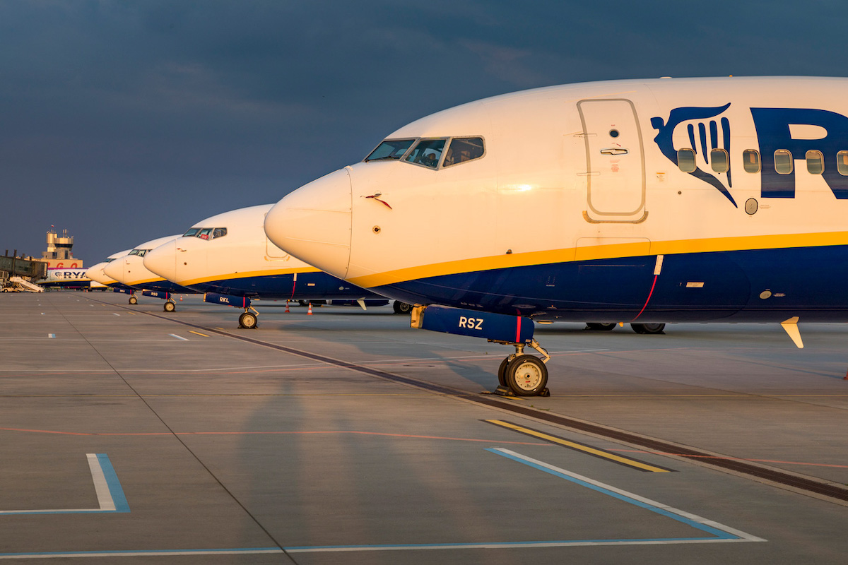 A series of Ryanair planes parked on the apron