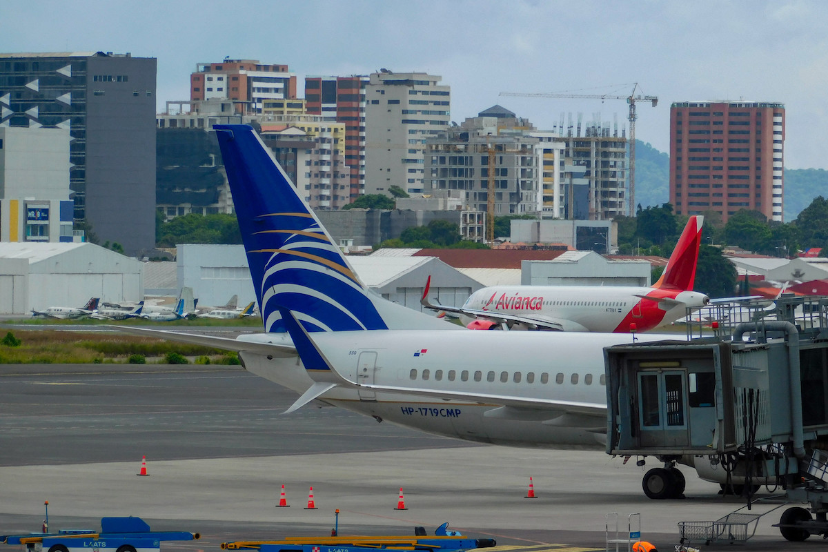 A Copa Airlines tail with an Avianca aircraft in the background.