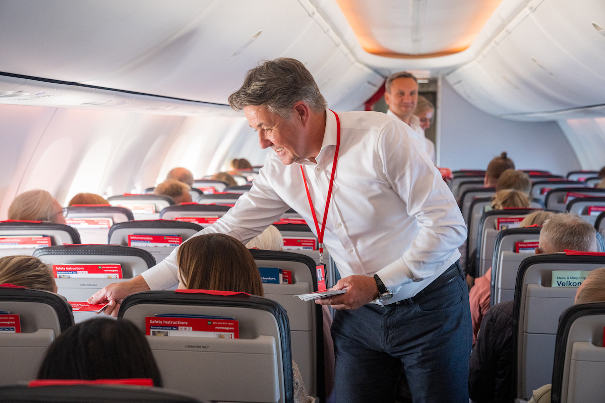 Norwegian Air CEO Geir Karlsen serves on a flight