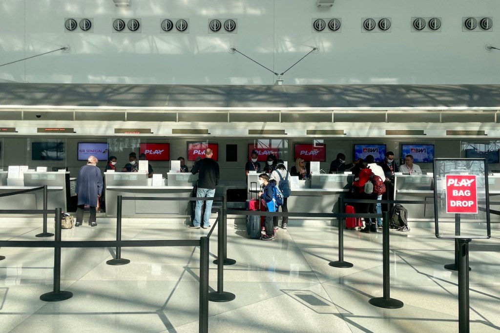 Travelers check-in for Play Airlines flights