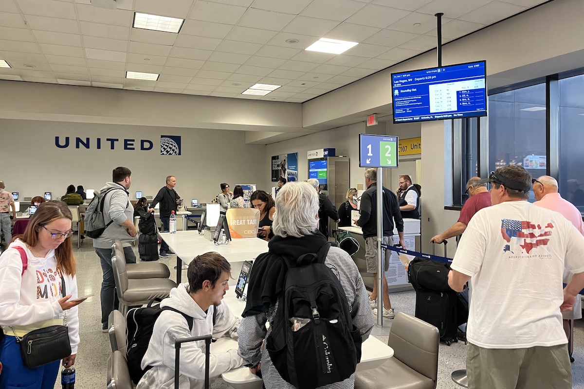 Travelers at a United Airlines gate