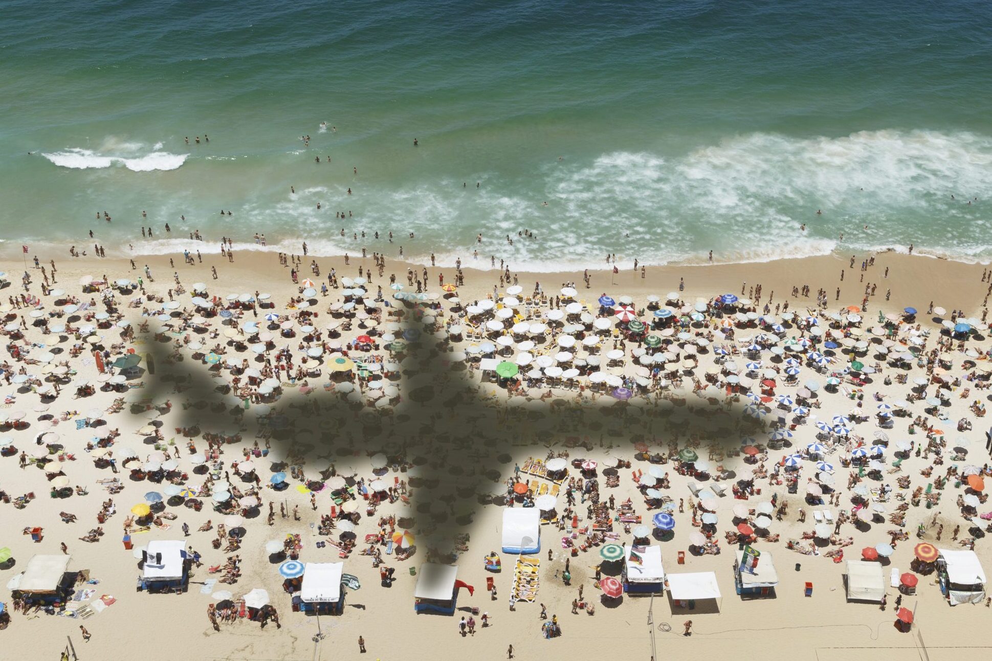 Airplane over beach in Rio.