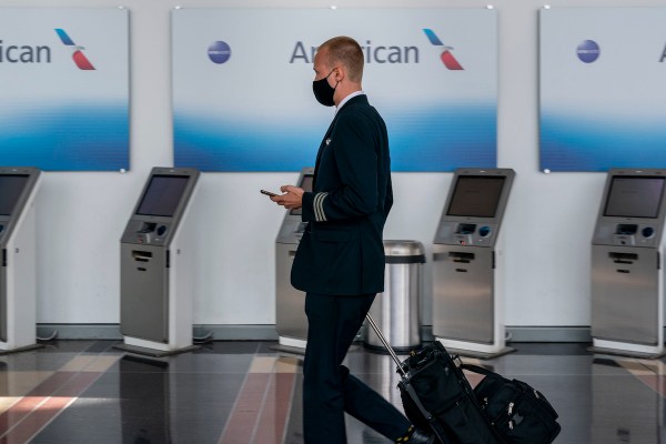 A pilot walks by an American Airlines counter