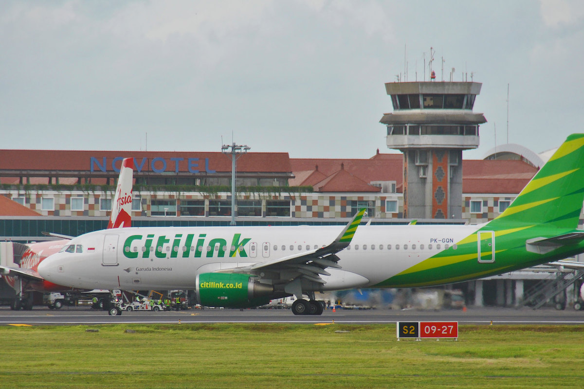 A Citilink plane taxis past an AirAsia plane