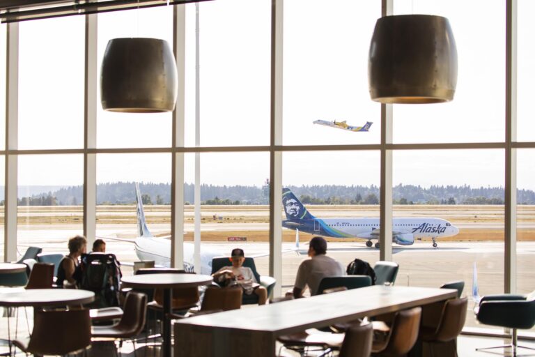 view through an airport lounge to an airline on the tarmac