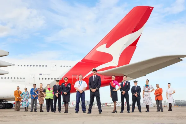 Qantas employees showcase a range of historical uniforms.